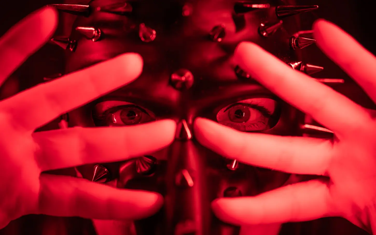 Abstract red-lit hands illustrating trust and boundaries in pet play