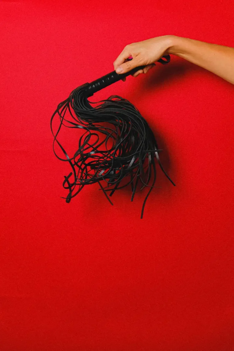Black bondage accessory on a red background